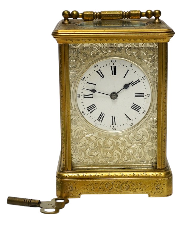 An engraved brass carriage clock by Richard & Cie, serial number 648, with key, 14cm. Condition - fair, dial cracked. Not tested as working